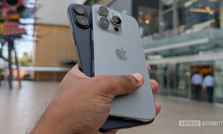 Apple iPhone 16 Plus in black color and iPhone 16 Pro in Natural Titanium color held out in hand