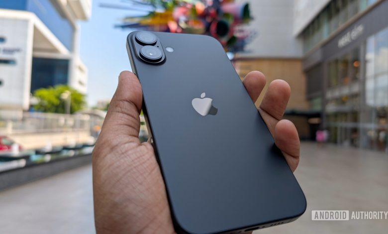 Apple iPhone 16 Plus in black color held out in hand