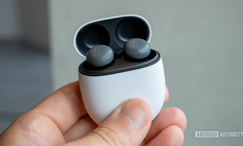 Google Pixel Buds Pro 2 in Hazel in charging case with lid open in person's left hand