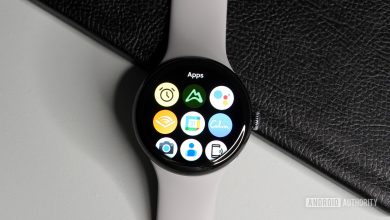 The Samsung Galaxy Watch 4 and Apple Watch Series 6 lying on a table showing the all-apps page.