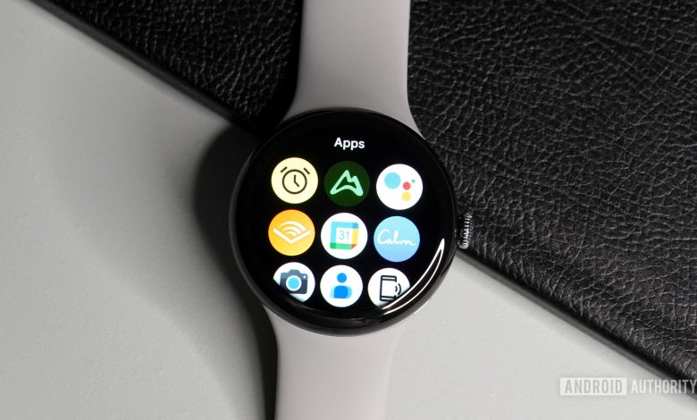 The Samsung Galaxy Watch 4 and Apple Watch Series 6 lying on a table showing the all-apps page.