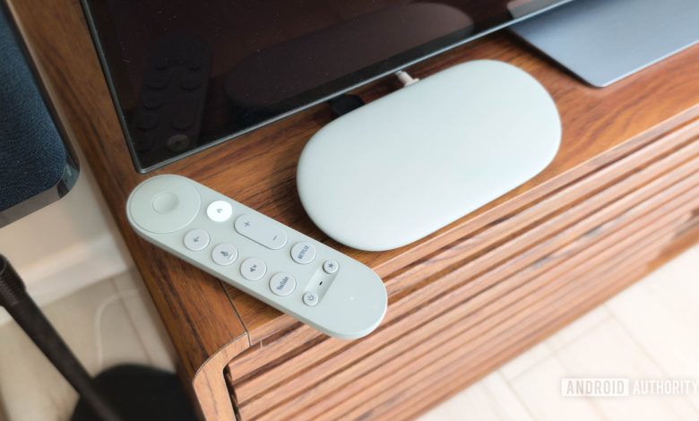 Google TV Streamer with remote on TV console hero