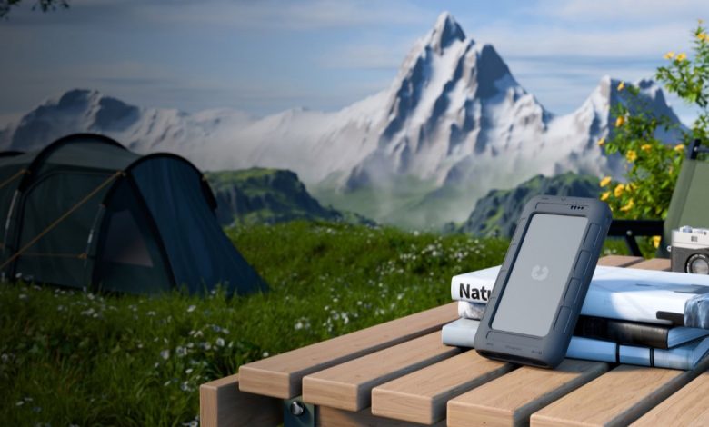 UnifyDrive UT2 on a table in front of a scenic background