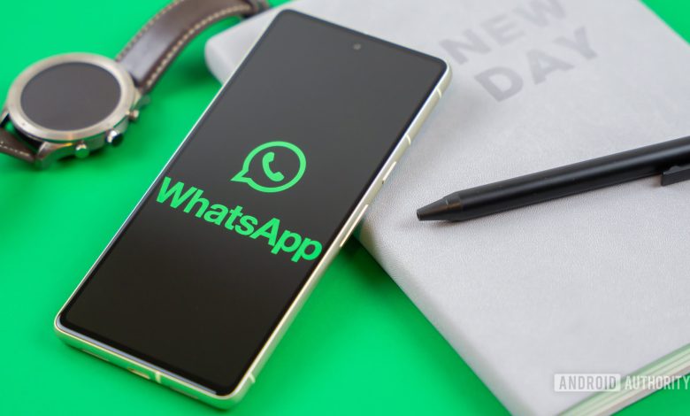 WhatsApp logo on smartphone next to everyday accessories Stock photo 1