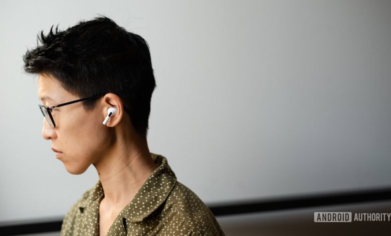 A person wears the Apple AirPods Pro (2nd generation) in profile view.