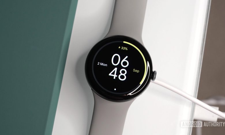 A Google Pixel Watch 3 rests on its charger.