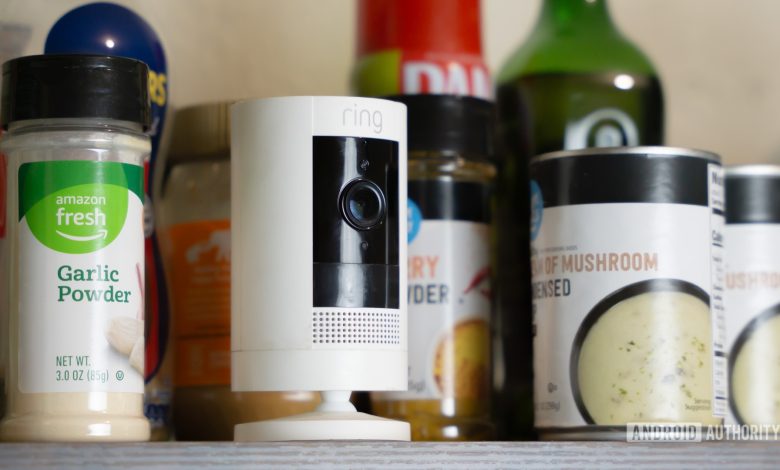 Ring camera next to spices, cans, and more kitchen items stock photo (1)