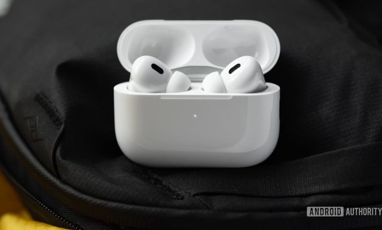 The Apple AirPods Pro (2nd generation) case is open and laying at an angle to show the earbuds and their sensors.