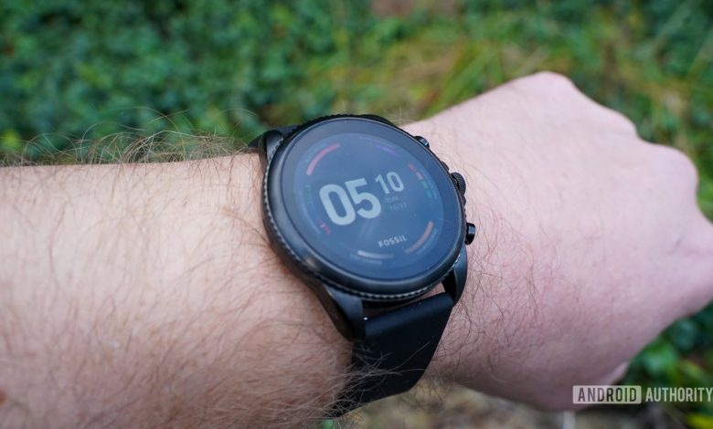 A user models a Fossil Gen 6 on wrist.