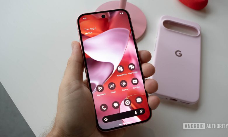 Google Pixel 9 in Peony in person's left hand showing Android 14 home screen