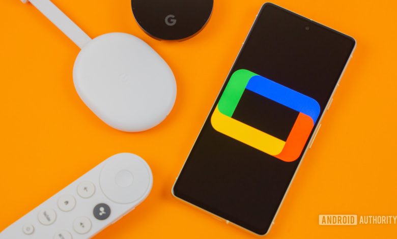 Google TV logo on smartphone next to Chromecast devices and remote Stock photo 3