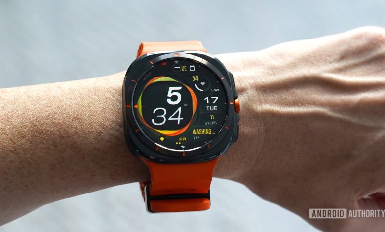 A Samsung Galaxy Watch Ultra displays the MD323 watch face