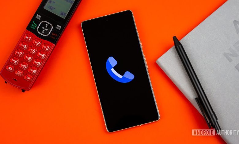 Stock photo of Phone by Google app on phone next to home phone agenda and pen 1