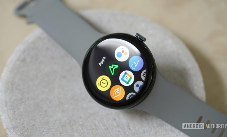 A Google Pixel Watch 3 rests on a stone dish, displaying its app library.