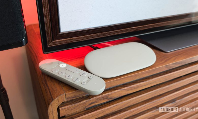 Google TV Streamer with Remote on TV console with red light