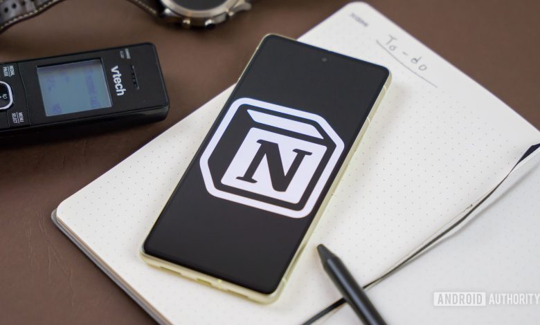 Notion logo on snartphone next to other office products Stock photo 2